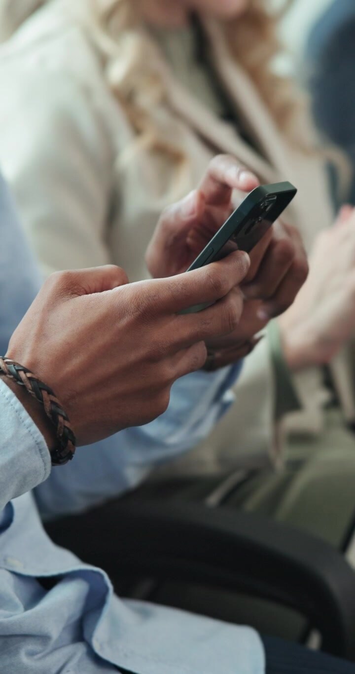 Close-up of Person Using Smartphone in Office Setting