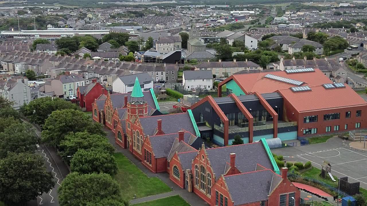 Ysgol Cybi welsh primary school aerial view circling circling green copper spire and Holyhead suburb