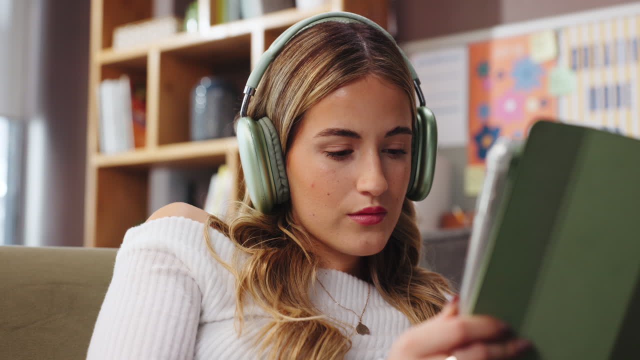 Woman using tablet with headphones on