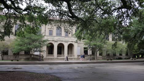 hill memorial library with students walking in the distance on the campus of louisiana state university in baton rouge, louisiana with stable establishing shot