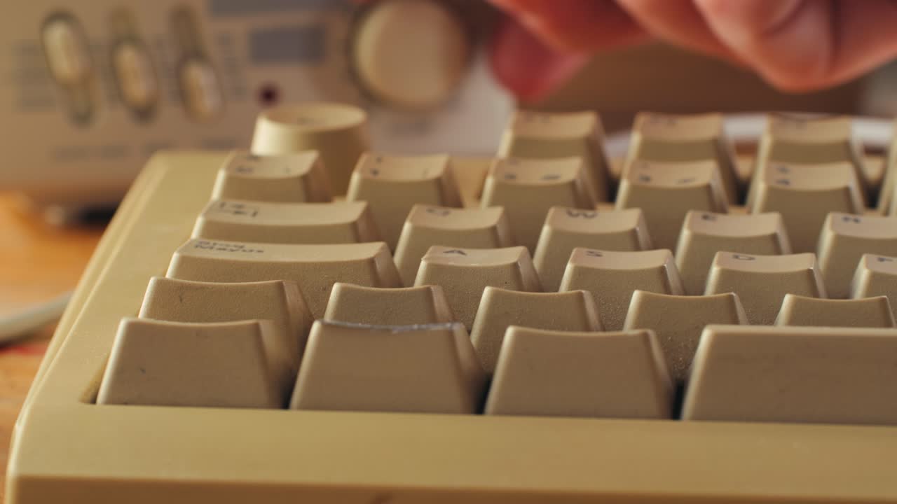 Man working and gaming on retro computer PC, IT engineer with vintage computer at home, using old fashion technology, close up of retro setup.