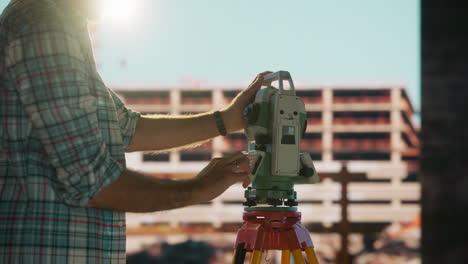 a man operating a total station on a construction site