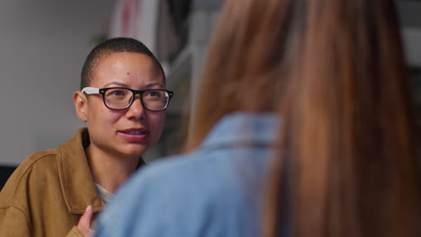 two women having a friendly conversation at work