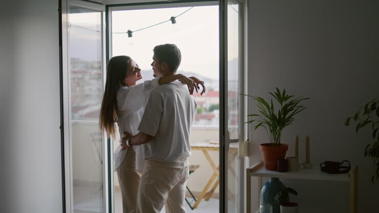 Love couple hugging hotel vertical closeup. Romantic people moving in dance