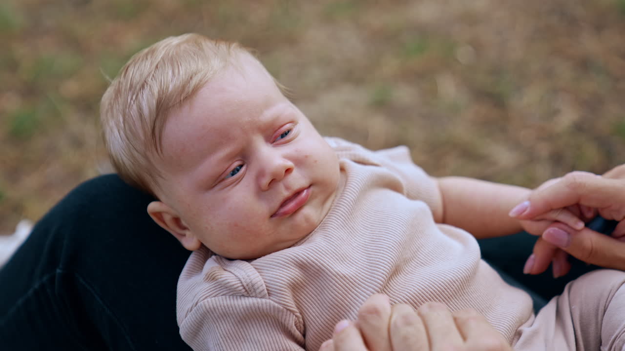 Baby boy being held by his mother
