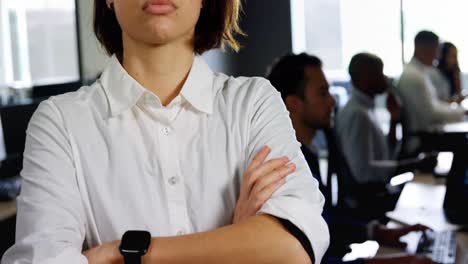 Female-executive-standing-with-arms-crossed-in-office-4k