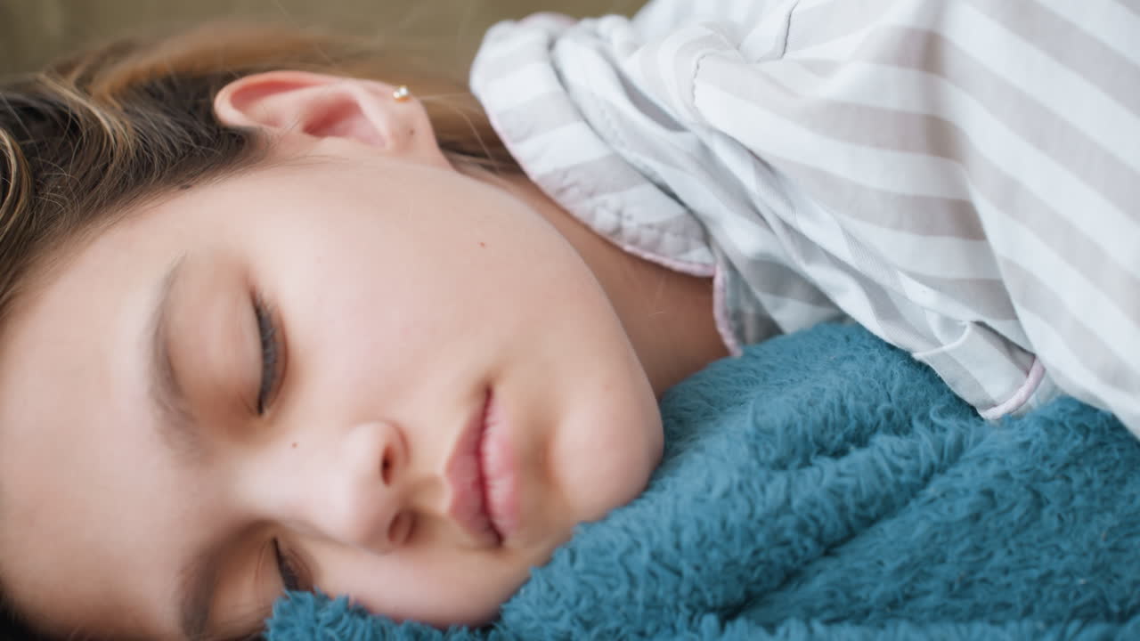 Woman Model Sleeping Closeup On Sofa, Face Resting On Teal Blanket With Relaxed Expression And Soft Eyelashes Intimate Beauty Portrait Capturing Calm Breathing And Peaceful Rest