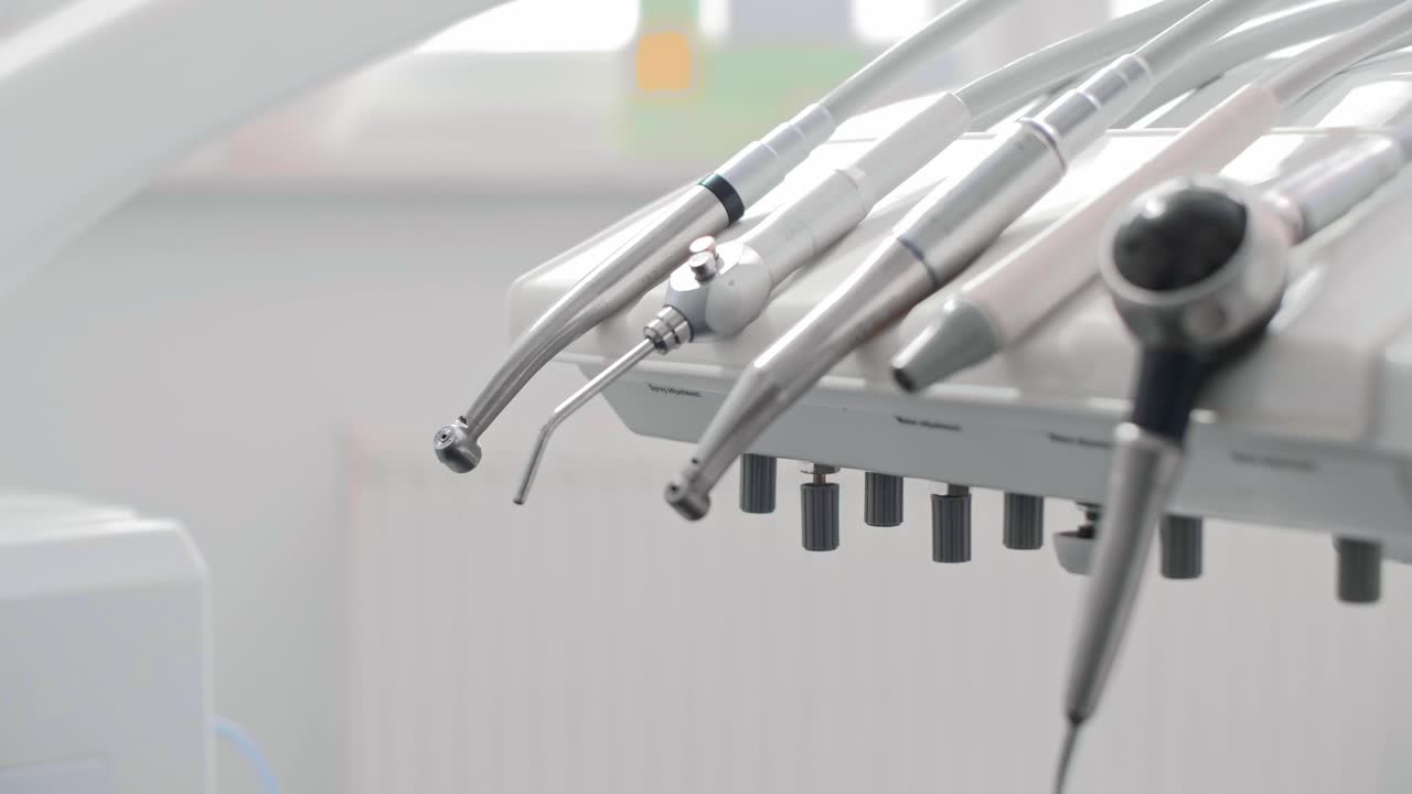 Dentist's hand taking dental equipment