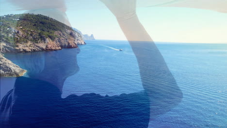 animation of landscape with ocean over senior caucasian man with surfboard at beach