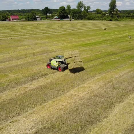tractor collecting straw bales