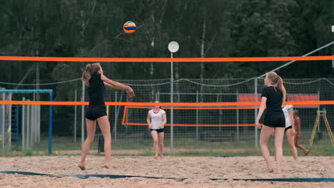 summer vacation sport and people concept - young woman with ball playing volleyball on beach