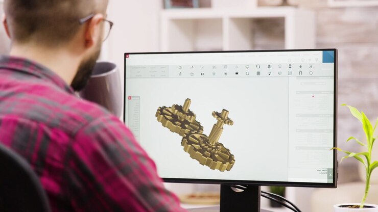 Ingegnere che progetta ingranaggi meccanici con software CAD 3D
