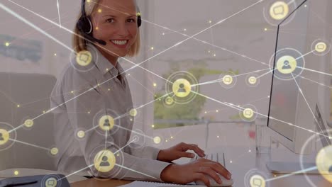 Animation-of-connections-with-icons-over-happy-caucasian-businesswoman-using-computer