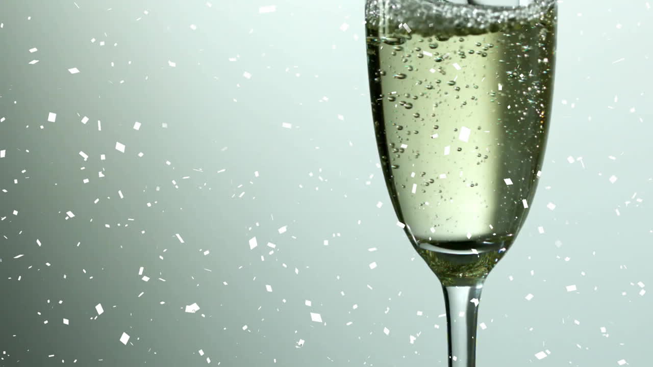 Falling confetti with champagne glass bubbling