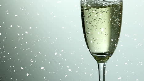 falling confetti with champagne glass bubbling