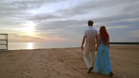 love couple walking on sea beach at sunrise. couple beach