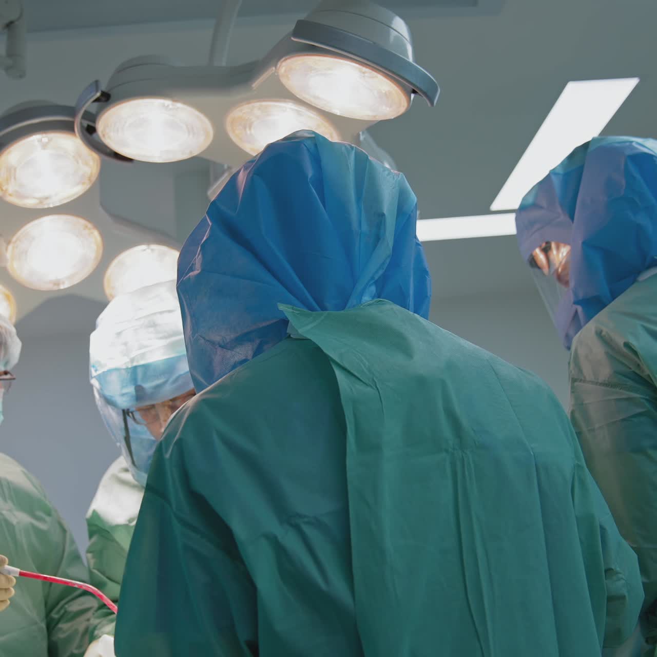 Group of doctors in safety suits in clinic. Medical workers in protective uniform from coronavirus pandemic in the hospital