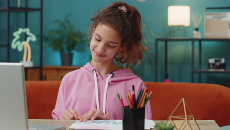 school girl drawing colorful picture i love mom with pencils on white paper greeting card for mother