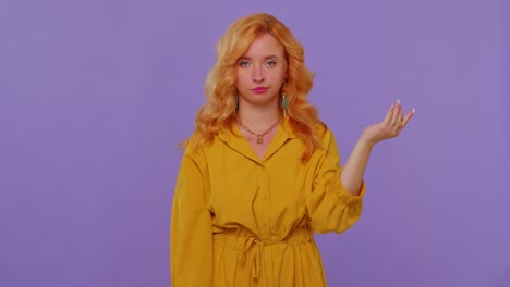 redhead girl in dress pointing at camera, showing stupid gesture blaming some idiot for insane plan