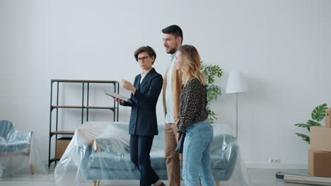 real estate agent showing a new home to a couple