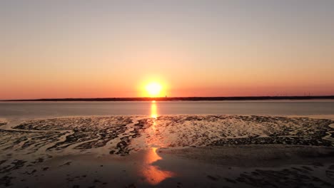 stunning clear orange sunset over tidal flat of north sea in germany near husum