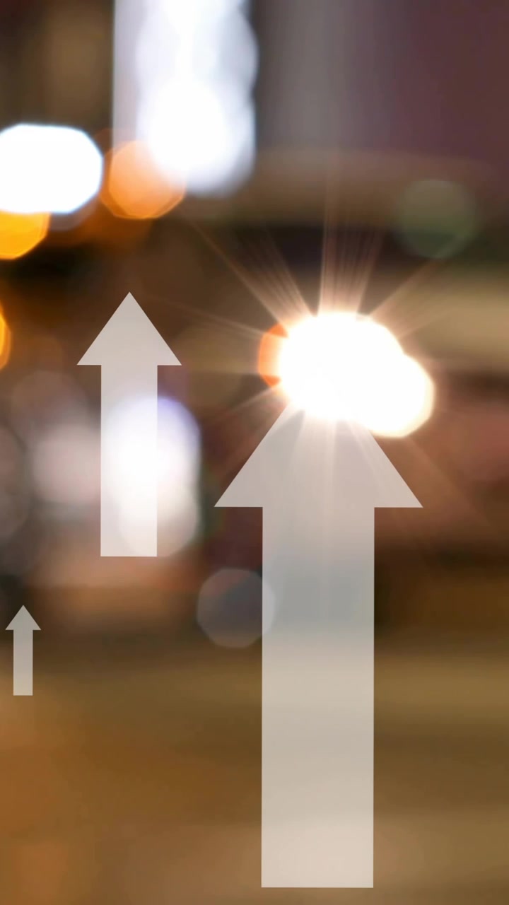 Animation of up arrows over blurred vehicles stopped on signal and diverse people crossing street