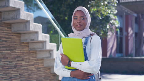portrait of a smiling female student with hijab on campus
