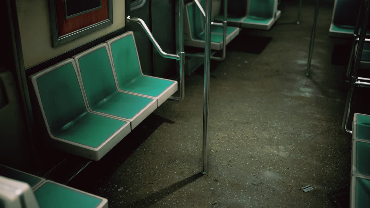 Abandoned subway car interior with teal seating on a quiet day