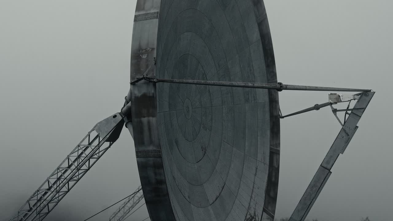 Large Industrial Satellite Dish Against Overcast Sky
