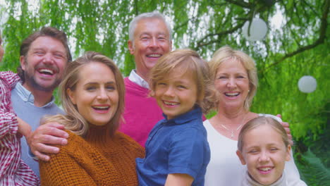 portrait of smiling multi-generation family at home in garden together