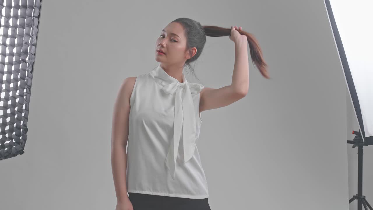 Studio Portrait of Woman in White Bow-Tie Blouse