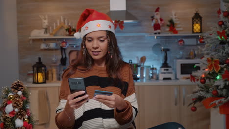 Festive-woman-using-smartphone-for-shopping-presents