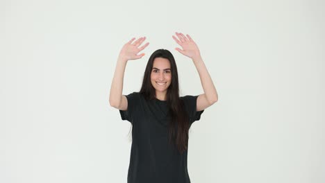 young woman smiling and waving hands on a white background