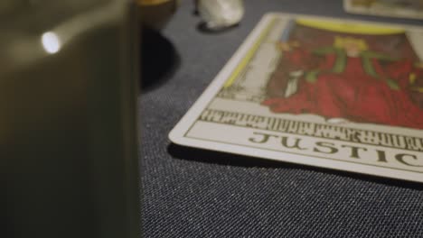 close up shot of tarot cards laid out for reading on table with candles 2