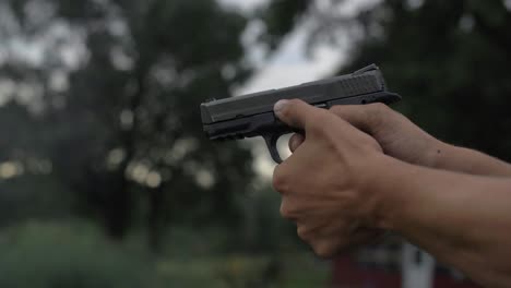 4k-60-fps-slow-mo-man-fires-44-mm-hand-gun-shooting-tight-shot-target-bullets-shell