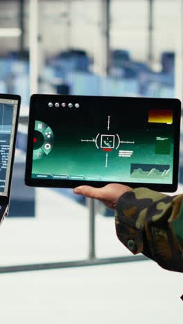 vertical video close up of army general and coworker in data center integrating ai into radar
