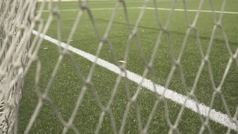 close-up view revealing intricate soccer field goal net texture, showcasing geometric diamond pattern with intersecting lines and mesh details from varying angular perspectives