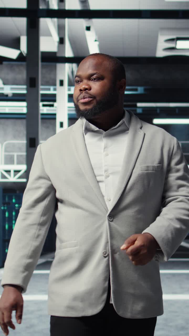 Vertical video Portrait of smiling admin doing yearly checkup on data center electronics