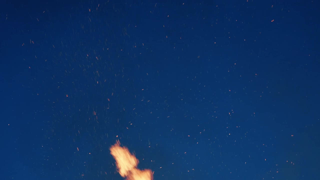 Fire Sparks Flying into the Night Sky