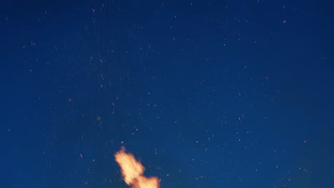 fire sparks flying into the night sky