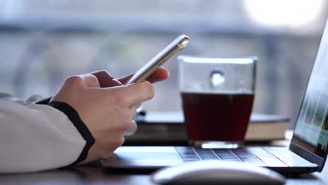 woman's hands holding a smartphone, scrolling, pointing, selecting something