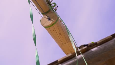 wooden pole with green straps for construction