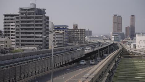 osaka urban background, monorail track and highway with apartments, japan