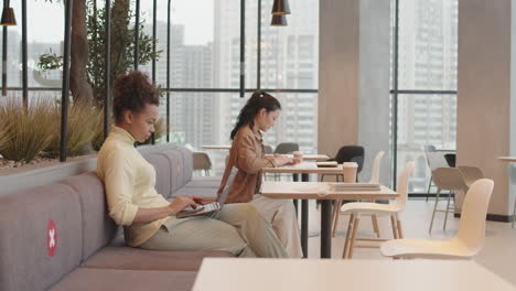 women keeping social distance in cafe