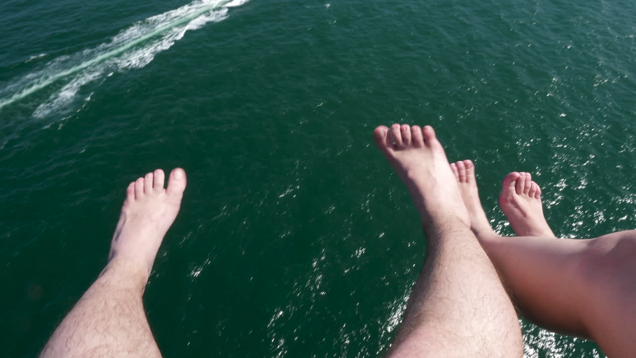 Couple feet over the sea while parasailing