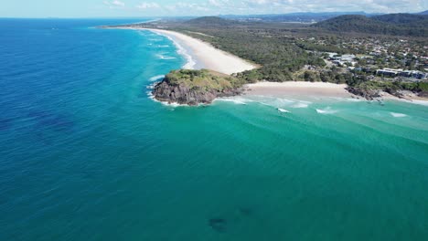 turquoise seascape surrounding norries headland in new south wales, australia - aerial drone shot