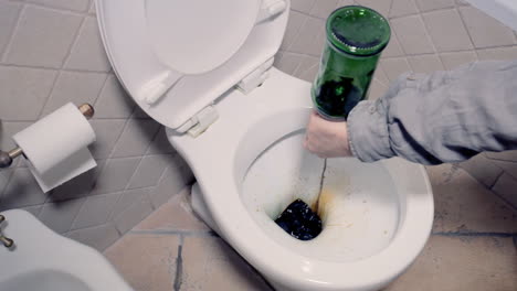 end sequence: dropping the content of a liquor bottle in the water closet and pulling the drain, getting free from alcoholism and bad habits