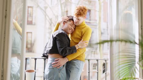 happy couple embracing on balcony