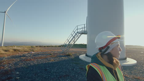 female technician on wind power station in the morning