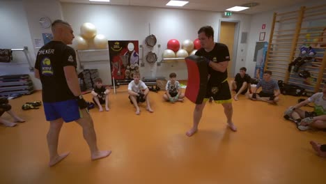 slow motion  video of a young boxer training for boxing game. boxer trainer with young men.